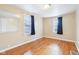 Bedroom with hardwood floors, large windows, and a mirror on the wall at 600 Alexandria Pike, Anderson, IN 46012