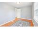 Bedroom with wood floors, light gray walls, one window and an open door at 600 Alexandria Pike, Anderson, IN 46012