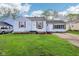 Charming one-story home with a well-maintained lawn, light colored siding, and wood-style shutters at 600 Alexandria Pike, Anderson, IN 46012