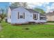 Charming one-story house with a well-maintained lawn and appealing light colored siding at 600 Alexandria Pike, Anderson, IN 46012