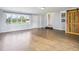 Open-concept living room with wood-look flooring, a barn door, and natural light at 600 Alexandria Pike, Anderson, IN 46012