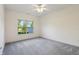Cozy bedroom with plush carpeting and a bright window overlooking the front yard at 6017 Riva Ridge Dr, Indianapolis, IN 46237