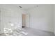Minimalist bedroom with neutral carpet, white walls, and ample closet space at 6017 Riva Ridge Dr, Indianapolis, IN 46237