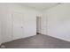 This bedroom features neutral colored walls, carpet flooring, and two doors at 6017 Riva Ridge Dr, Indianapolis, IN 46237