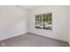 This bedroom features neutral colored walls, carpet flooring, and a window at 6017 Riva Ridge Dr, Indianapolis, IN 46237