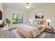 Bright bedroom featuring a modern bed frame, serene decor, and ample natural light at 6017 Riva Ridge Dr, Indianapolis, IN 46237