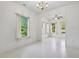 Bright dining room featuring white walls, chandelier, and large windows overlooking the lawn at 6017 Riva Ridge Dr, Indianapolis, IN 46237