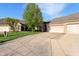 Driveway of a well-maintained brick home featuring an attached garage with blue sky at 6017 Riva Ridge Dr, Indianapolis, IN 46237