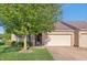 Charming brick home featuring an attached garage and lush lawn with a mature shade tree at 6017 Riva Ridge Dr, Indianapolis, IN 46237