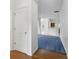Hallway featuring hardwood flooring and access to the home's interior with carpeted floors at 6017 Riva Ridge Dr, Indianapolis, IN 46237