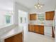 Well-lit kitchen featuring wooden cabinets, white appliances, and bar seating at 6017 Riva Ridge Dr, Indianapolis, IN 46237