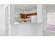 Kitchen with wooden cabinets, white appliances, and bar seating in an open floorplan at 6017 Riva Ridge Dr, Indianapolis, IN 46237