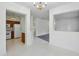 Open-concept kitchen with white appliances and view to additional living space at 6017 Riva Ridge Dr, Indianapolis, IN 46237