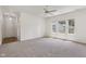 Bright living room with neutral carpet, white walls, and plenty of natural light from the large windows at 6017 Riva Ridge Dr, Indianapolis, IN 46237