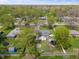 Aerial view of home with lush, mature trees in backyard featuring an above-ground pool, trampoline, and shed at 615 W Stop 11 Rd, Indianapolis, IN 46217