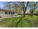 Lush backyard with mature trees and a tire swing at 615 W Stop 11 Rd, Indianapolis, IN 46217