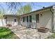 View of the house back exterior with chairs, picnic table, and patio at 615 W Stop 11 Rd, Indianapolis, IN 46217