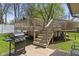 Backyard features a wooden deck with stairs and a BBQ grill at 615 W Stop 11 Rd, Indianapolis, IN 46217