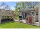 Backyard featuring a deck, grill, playhouse, and lush green lawn at 615 W Stop 11 Rd, Indianapolis, IN 46217