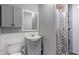 Neutral bathroom with white toilet and vanity, medicine cabinet and a shower stall at 615 W Stop 11 Rd, Indianapolis, IN 46217
