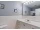 Well-lit bathroom with white vanity and tiled walls at 615 W Stop 11 Rd, Indianapolis, IN 46217
