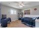 Bedroom featuring a ceiling fan, a window, carpeted floors, and fun decor at 615 W Stop 11 Rd, Indianapolis, IN 46217
