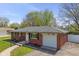 Well-maintained brick home with an attached garage and tidy landscaping, presenting a welcoming curb appeal at 615 W Stop 11 Rd, Indianapolis, IN 46217