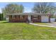 Charming brick home with manicured lawn, walkway, and attached garage at 615 W Stop 11 Rd, Indianapolis, IN 46217