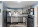 Clean and modern kitchen with stainless steel appliances, granite countertops and wood-look floors at 615 W Stop 11 Rd, Indianapolis, IN 46217