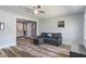 Comfortable living room features wood floors and a gray couch at 615 W Stop 11 Rd, Indianapolis, IN 46217
