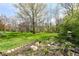 Expansive backyard featuring lush greenery, mature trees, and serene landscaping at 6205 Albury Dr, Indianapolis, IN 46236