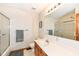A bright bathroom with a glass door shower and wooden vanity at 6205 Albury Dr, Indianapolis, IN 46236