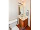 Cozy half bath with a stylish vanity cabinet, mirror, and towel rack, ideal for guests at 6205 Albury Dr, Indianapolis, IN 46236