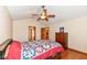 Bedroom featuring a ceiling fan, wood floors, and warm neutral walls at 6205 Albury Dr, Indianapolis, IN 46236