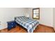 Cozy bedroom with wood floors, neutral walls, and a window for natural light at 6205 Albury Dr, Indianapolis, IN 46236