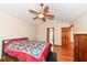 Bright bedroom featuring a ceiling fan, wood floors, and warm neutral walls at 6205 Albury Dr, Indianapolis, IN 46236
