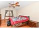 View of the bedroom with a ceiling fan, neutral walls, and hardwood floors at 6205 Albury Dr, Indianapolis, IN 46236
