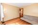 Cozy bedroom with wood floors and a neutral wall color, ideal for relaxation at 6205 Albury Dr, Indianapolis, IN 46236