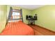Bedroom with green walls featuring wood trim, a large window, and natural light at 6205 Albury Dr, Indianapolis, IN 46236