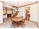 Charming dining room featuring a wood table, four chairs, tile floors, and views into the kitchen at 6205 Albury Dr, Indianapolis, IN 46236