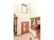 Spacious foyer with a decorative front door, high ceilings and entry to living room with hardwood floors at 6205 Albury Dr, Indianapolis, IN 46236