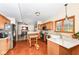 Well-equipped kitchen with oak cabinetry, stainless steel appliances, and a functional center island at 6205 Albury Dr, Indianapolis, IN 46236
