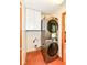 Compact laundry room featuring a stacked washer and dryer, plus additional storage at 6205 Albury Dr, Indianapolis, IN 46236