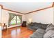 Comfortable living room features hardwood floors, crown molding and large windows for natural light at 6205 Albury Dr, Indianapolis, IN 46236