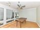 Well-lit sunroom with hardwood floors and large windows offering natural light and neighborhood views at 6205 Albury Dr, Indianapolis, IN 46236