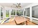 Bright sunroom featuring many windows and a glass door to the backyard at 6205 Albury Dr, Indianapolis, IN 46236