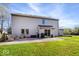 Spacious backyard with a patio area, seating, and a well-maintained lawn at 6211 W Bayfront Shores, McCordsville, IN 46055
