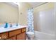 Kid-friendly bathroom with a single sink, vanity, and bathtub with a fun dinosaur-themed shower curtain at 6211 W Bayfront Shores, McCordsville, IN 46055