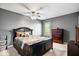 Cozy bedroom with dark wood furniture, soft lighting, and a calming gray color scheme at 6211 W Bayfront Shores, McCordsville, IN 46055