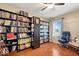 Cozy bedroom with hardwood floors, built-in bookshelves, and a comfortable seating area by the window at 6211 W Bayfront Shores, McCordsville, IN 46055